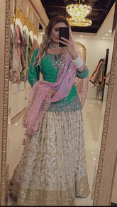 Punjabi Style White Color Chinon silk Sequence Work Lehenga With Green Top With Dupatta